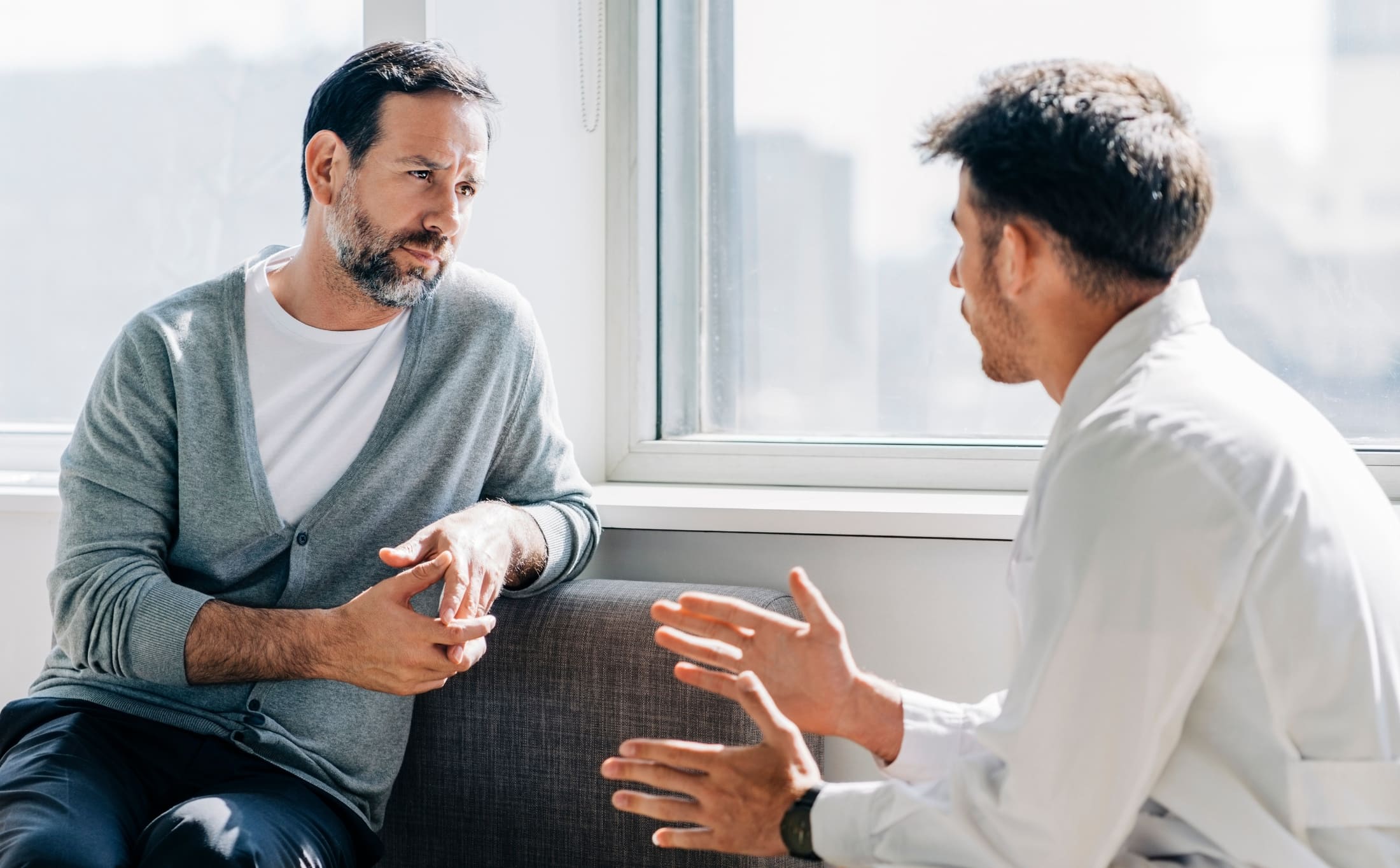 A man talks to a therapist during a burnout treatment in Raleigh.