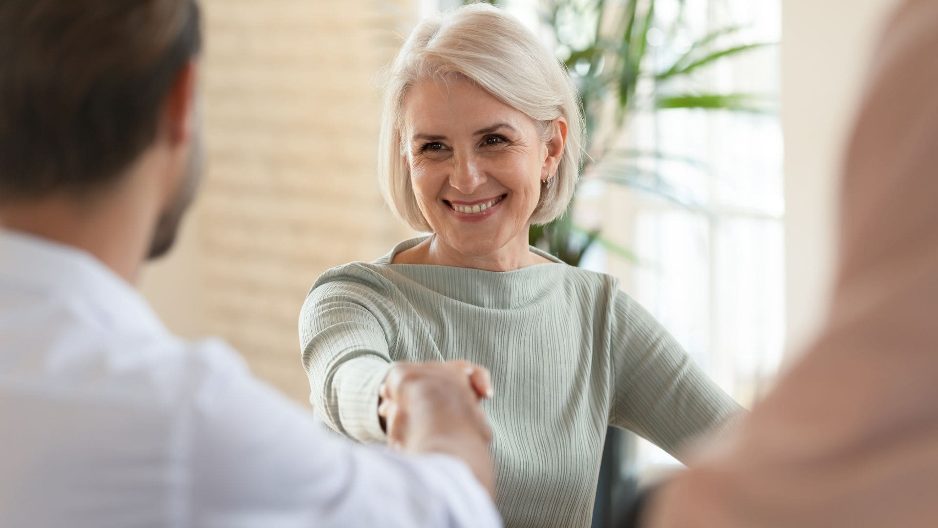 Woman shaking hands with a specialist at a Medicare psychiatry in Raleigh, NC.
