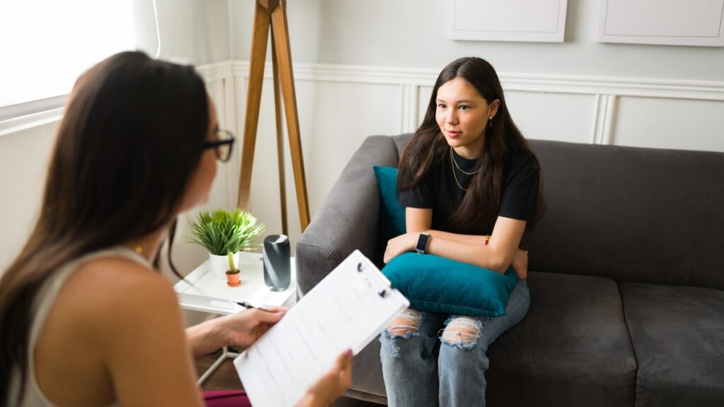 A young woman shares her struggle with ADHD during a personalized treatment session.